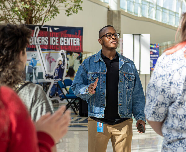 Tour guide for the ACE Management program BOK Tour speaking to group