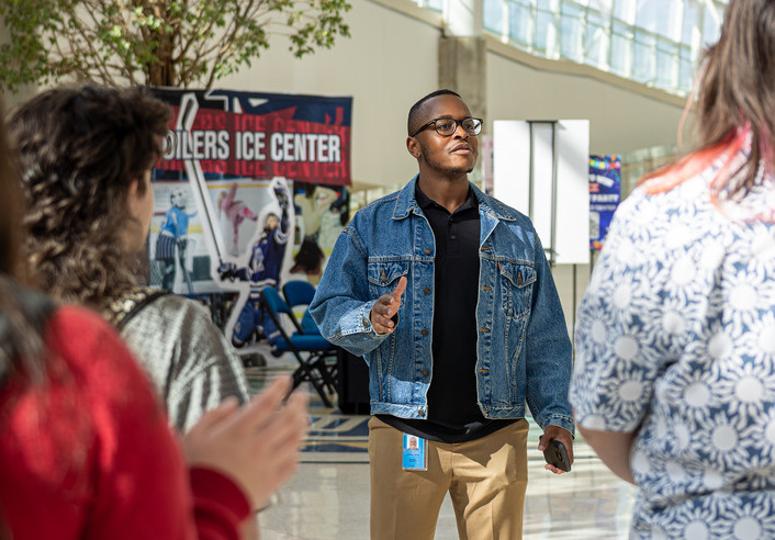 Tour guide for the ACE Management program BOK Tour speaking to group