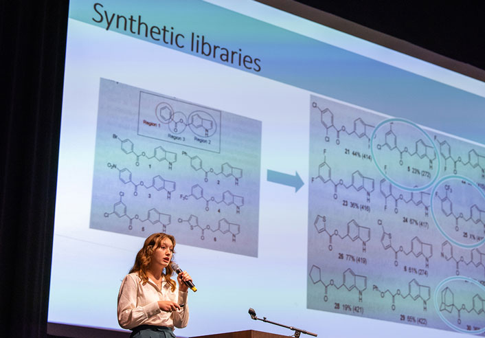 University of Tulsa student Kinlie Gililland presenting in front of a large screen
