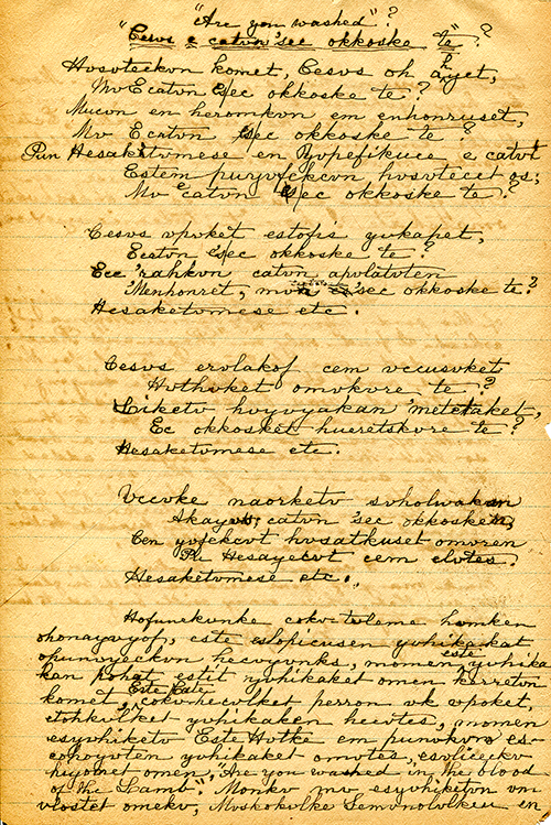 Photograph of a yellow sheet of paper with black ink handwriting