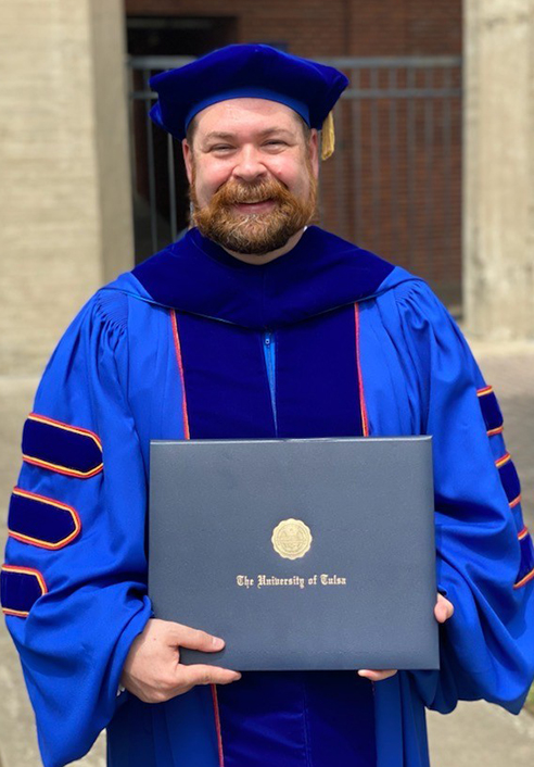 Blake Connelly portrait wearing cap and gown from graduation